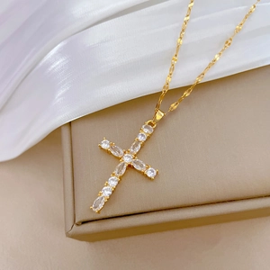 Titanium steel cross necklace with oval zirconia crystals on a brown jewelry box