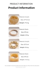 Detail view of bohemian resin bangles with amber marble textures and gold metal buckles
