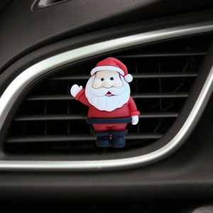 Detailed view of a Santa Claus car air vent clip accessory on a black interior vent