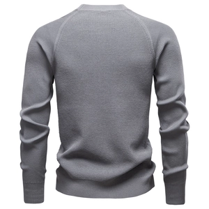 Detail of grey men's crewneck knit sweater showcasing premium textured fabric and weave