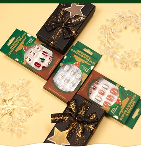 Detailed view of Christmas press-on nails featuring Santa Claus and snowflake patterns