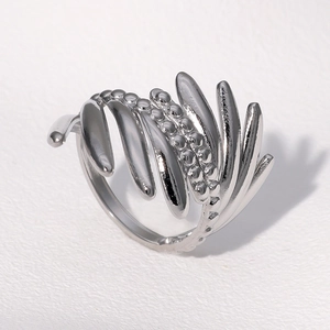 Detailed view of silver braided stainless steel ring with textured wheat pattern