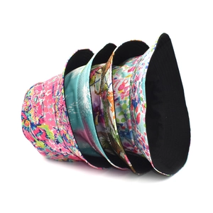 Set of colorful printed bucket hats in various tropical and abstract patterns for sun protection