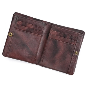 Detail view of genuine leather bifold wallet showing card slots and snap closure