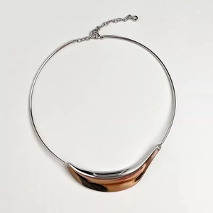 Detail of silver snake bone choker with two-tone champagne gold curved accent