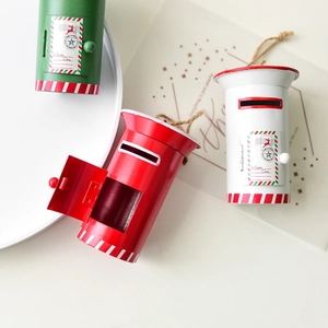 Three colorful Christmas mailbox ornaments in red, green, and white with hanging ropes