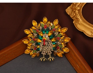Detailed macro view of retro turkey brooch with colorful rhinestones on gold alloy base