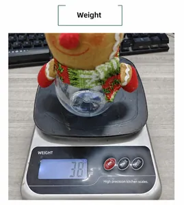 Christmas gingerbread man candy jar being weighed on a scale to show its light weight