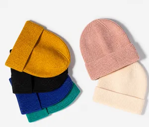 Detail showing various colors of ribbed knit beanies with soft thick texture and folded cuff