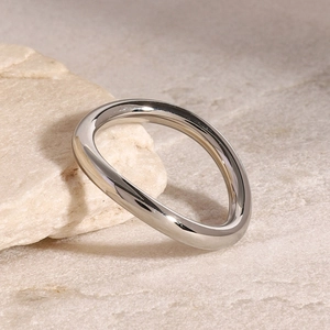 Macro shot of minimalist silver wavy irregular stainless steel ring with mirror finish