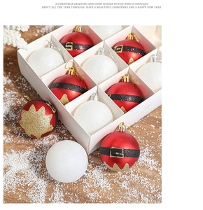 Detailed view of red and white Christmas baubles in a festive box on wooden surface