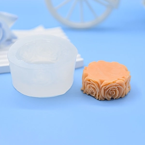 Detailed rose flower silicone mold shown with finished orange craft on light blue background