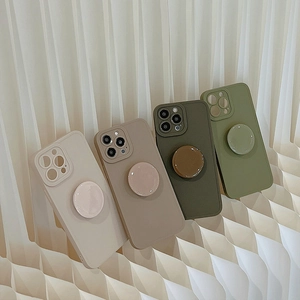 Close-up of four iPhone cases with pop sockets in beige, brown, army green, and matcha