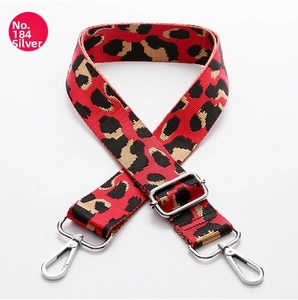 Detail of red leopard print crossbody strap with silver metal lobster clasps