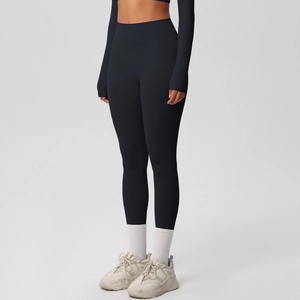 Close-up of black high-waisted seamless yoga pants and long sleeve top with thumbholes