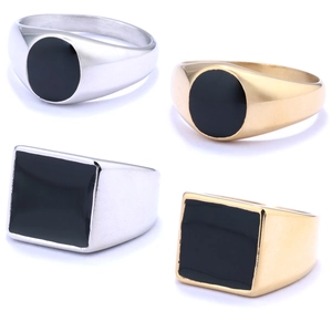Detail of round and square men's signet rings with black inlay in gold and silver finish