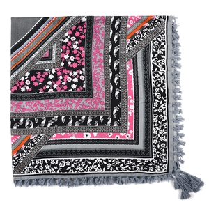 Detail of bohemian patchwork square scarf with floral paisley patterns and grey fringe edge