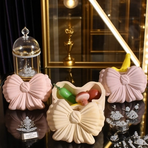 Detailed view of bow storage boxes and a diamond crown accessory in a luxury setting