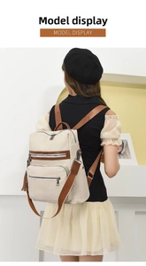 Back view of woman wearing soft PU leather backpack with tassel and brown straps