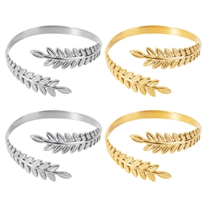 Detail view of gold and silver laurel leaf cuffs featuring adjustable C-shape design