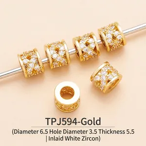 Macro view of gold-plated brass cylinder spacer beads with pavé cubic zirconia for DIY jewelry