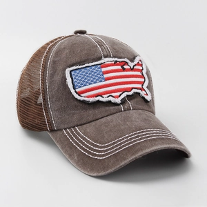 Close-up of vintage American flag map patch on brown washed cotton trucker hat
