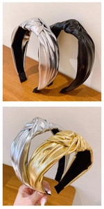Detail of metallic knot headbands in gold and silver showing the shiny PU leather texture