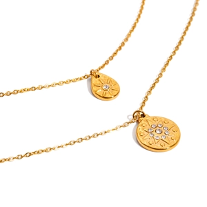 Double layered gold stainless steel necklace with rhinestone drop and sunburst pendants