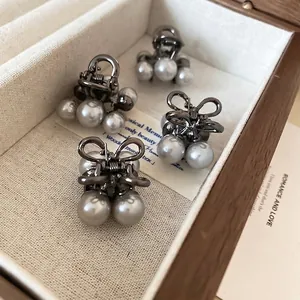 Set of 4 mini gun-grey hair clips with elegant white pearls and bow-tie designs