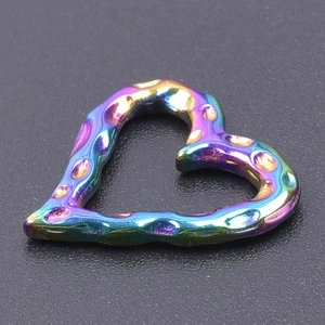 Macro shot of 18k gold plated stainless steel heart charm with colorful hammered texture