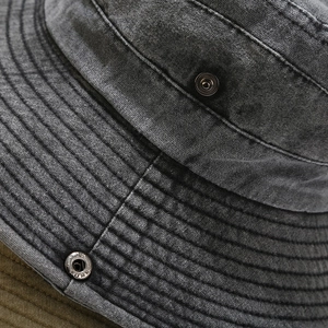 Detail of washed grey cotton sun hat with metallic snap button and reinforced stitching