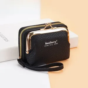 Detail of black pebbled leather wallet featuring vintage gold hardware and hand strap