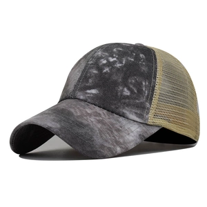Side view of washed tie-dye baseball cap featuring khaki mesh back and stitched brim detail