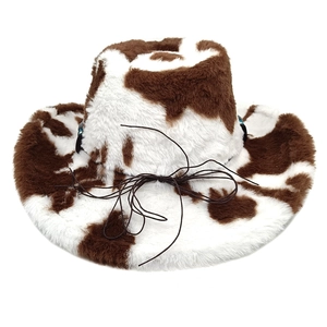 Detailed close-up of cow print plush cowboy hat with brown decorative cord on top
