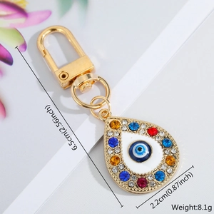 Detail showing 6.5cm Evil Eye keychain size and weight with colorful rhinestones