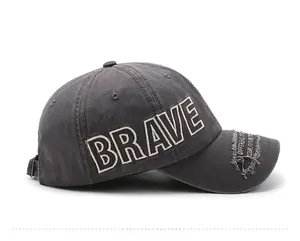 Macro detail of BRAVE embroidery and distressed patch on charcoal baseball cap