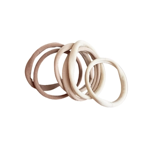Set of 5 earth-tone elastic fabric hair ties in brown and beige shades on white background