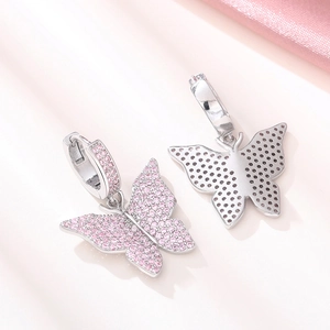 Detailed view of pink zircon butterfly earrings with polished silver hollow back design