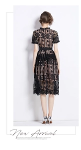 Detail of elegant black hollow floral lace midi dress with waist belt from the back view