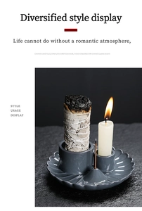 Detail of dark grey wave-edge ceramic holder with sage bundle and candle slot