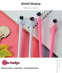 Close-up of pink and white astronaut gel pens with 3D silicone cartoon toppers