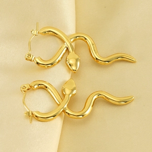 Elegant 18k gold plated snake shaped hoop earrings on champagne silk background