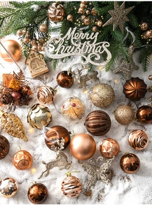 Detailed set of bronze Christmas baubles, reindeer and star ornaments on snowy background