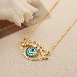 Golden Evil Eye pendant necklace featuring teal stone and cubic zirconia inlay