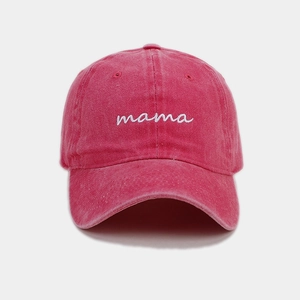 Detailed close-up of white mama embroidery on a vintage rose red washed cotton baseball cap