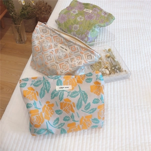 Detailed close-up of three vintage jacquard floral pouches with embroidery and metal zippers