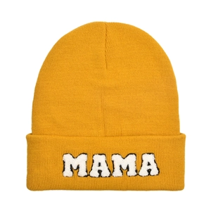 Detail of yellow knit beanie featuring plush MAMA letter embroidery on the folded cuff
