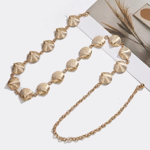Detailed view of the gold shell shaped link chain with a polished metallic finish