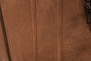Macro view of brown suede jacket showing fine fabric texture and metal zipper details