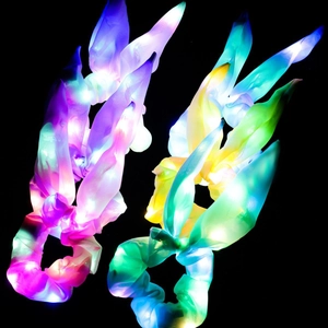 Glow-in-the-dark LED scrunchies with bunny ears in gradient purple and yellow colors